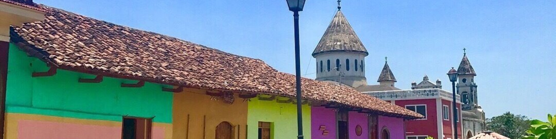 A beautiful yet quiet street during midday likely because it is 30 degrees C+ at this time of year