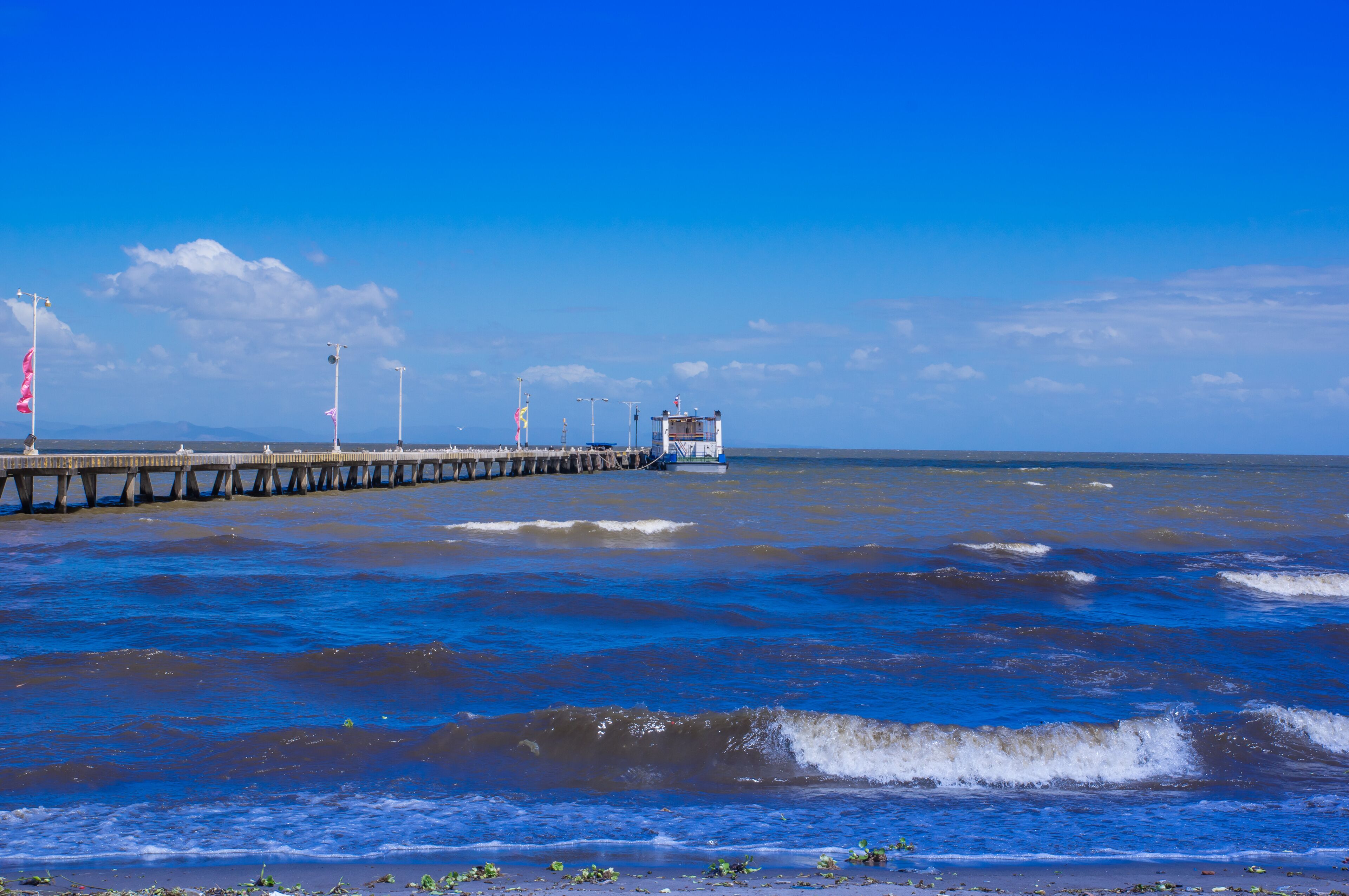 Beautiful outdoor view of wooden Pier Leading out into Lake in a gorgeous sunny day and blue water in Granada