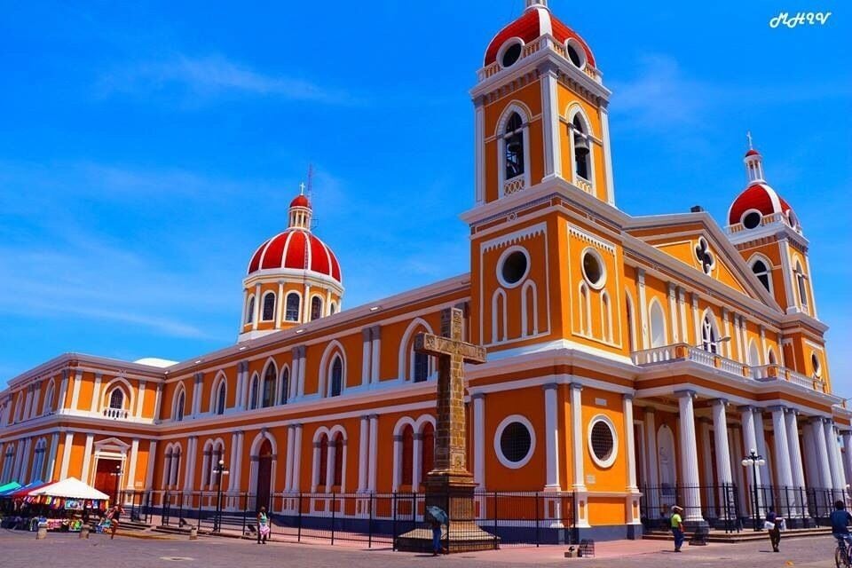 A large, ornate church with two red domes and a central tower.