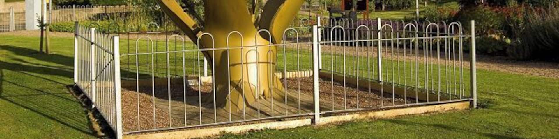 Dyce Community Garden, near to Dyce, Aberdeen, Great Britain. Dyce Community Garden. Until a few years ago this was a patch of waste ground. In the foreground is a sculpture based around a ruptured oil pipeline. The Scottish saltire proudly flies in the background.