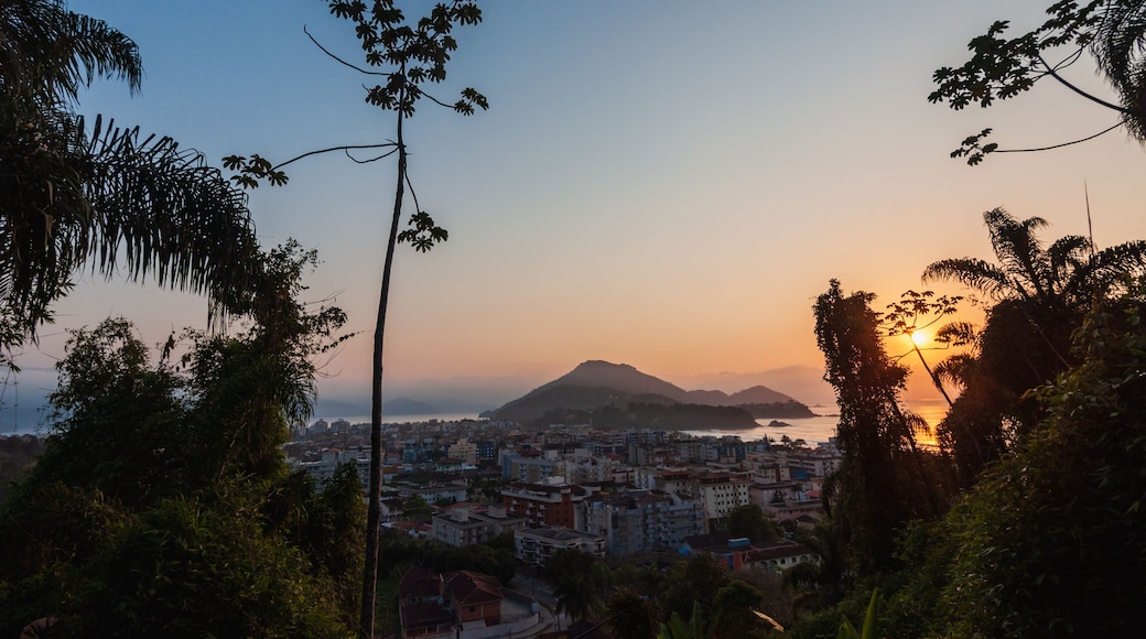 Sunrise at Ubatuba sea with an aerial view of the city among coastline trees and vegetation
