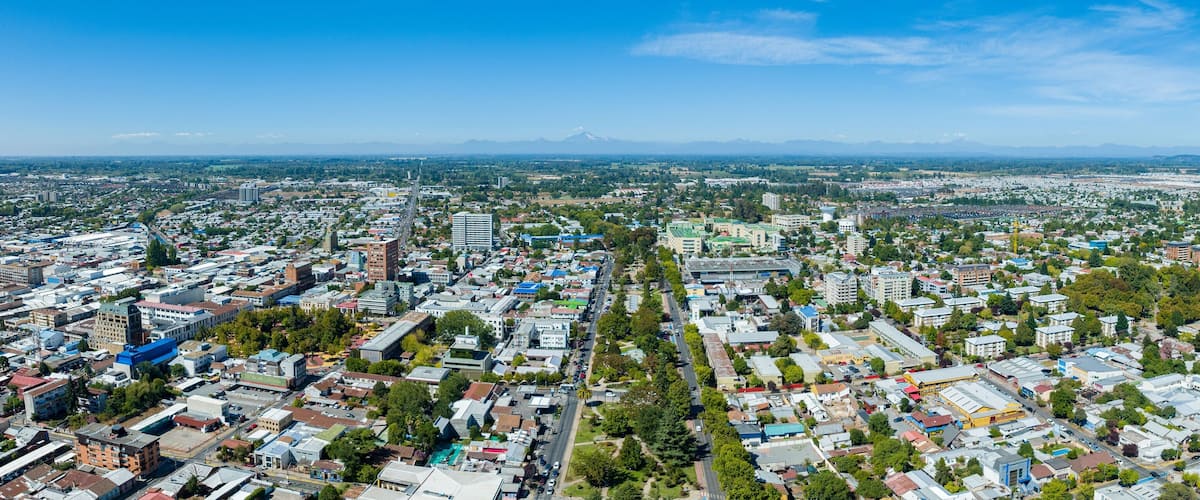 A cityscape with a prominent mountain in the background.