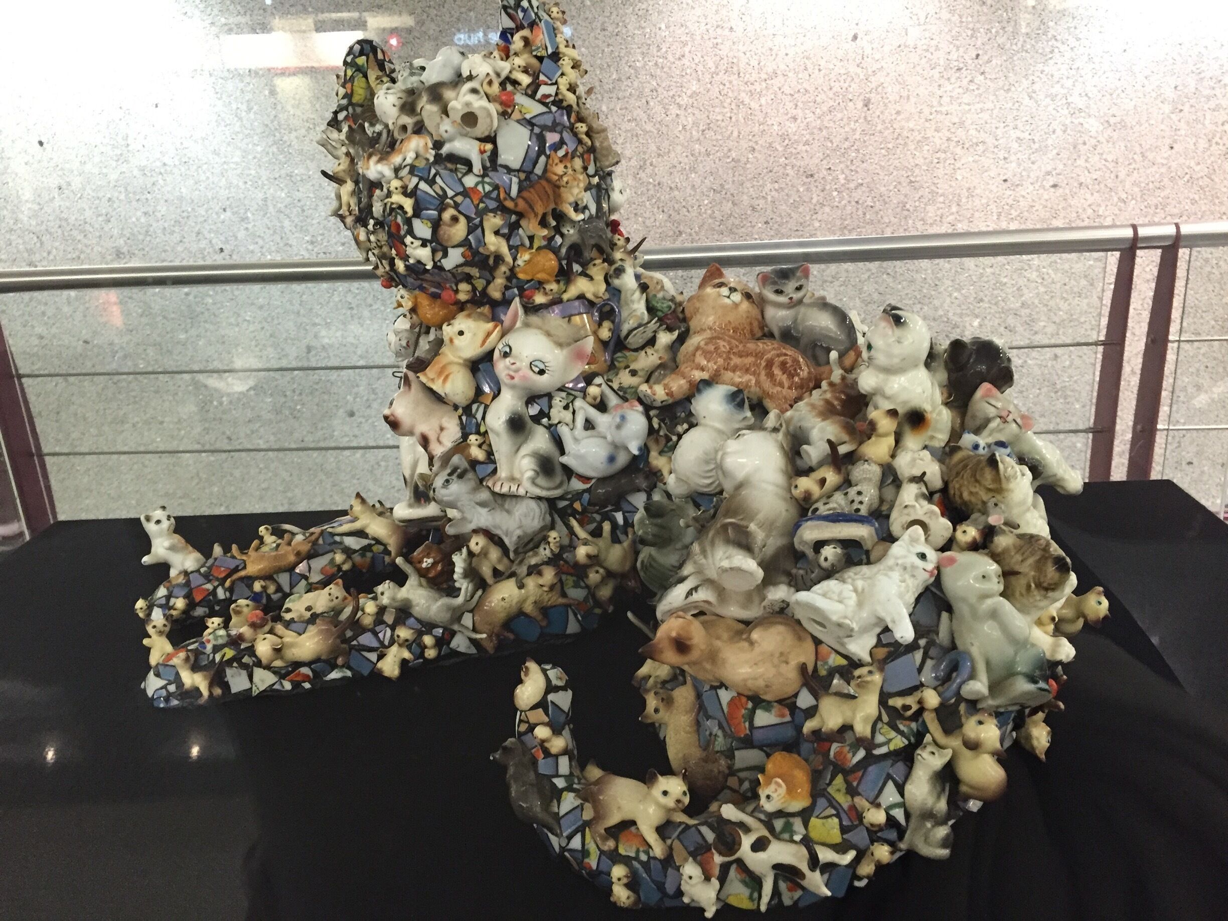 #discovery. Mary Engel sculpture called cat. Made with a ton of figurines. On display at the airport . 