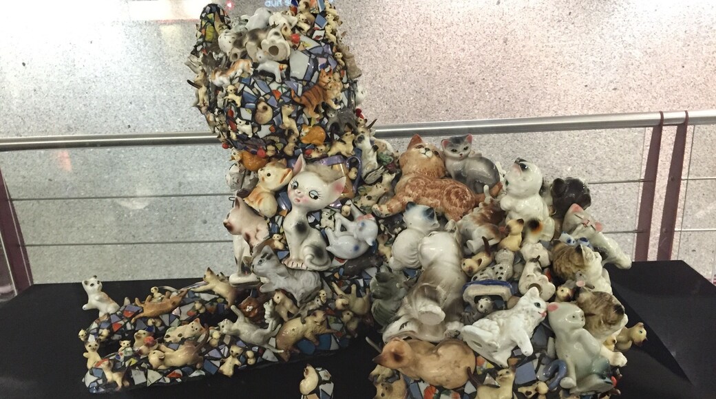 #discovery. Mary Engel sculpture called cat. Made with a ton of figurines. On display at the airport .