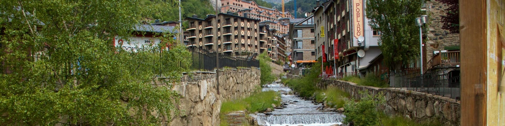 Arinsal which includes a small town or village, a river or creek and a waterfall
