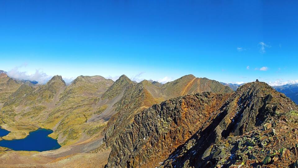 A mountainous landscape with rocky terrain and two lakes.