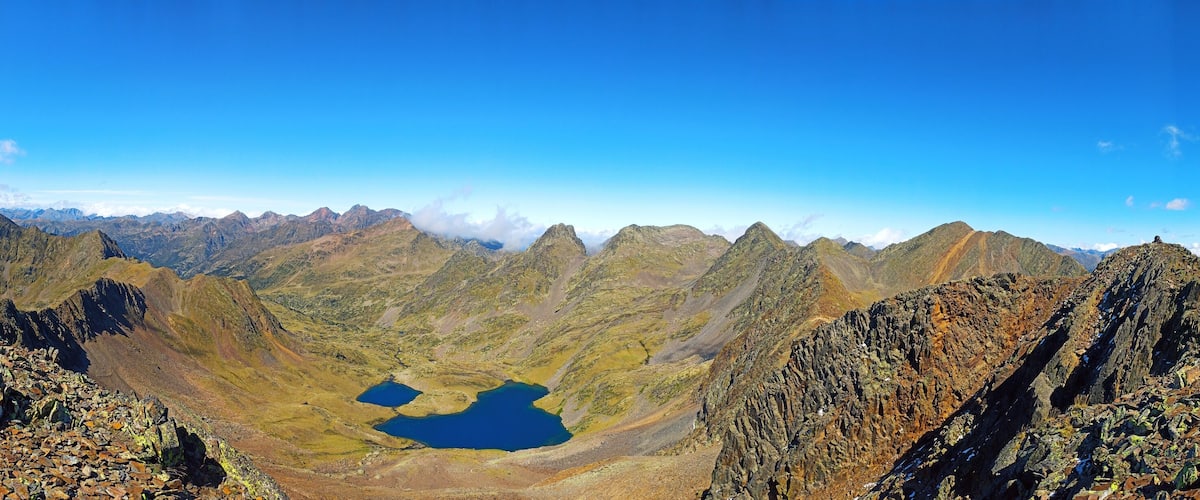 A mountainous landscape with rocky terrain and two lakes.
