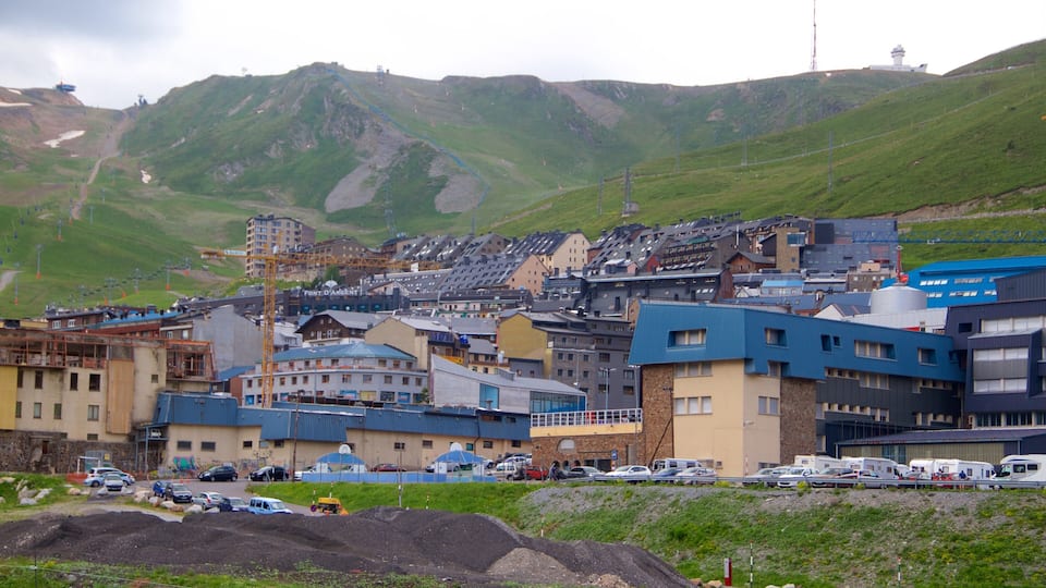 A town with buildings, a mountain, and a lighthouse.