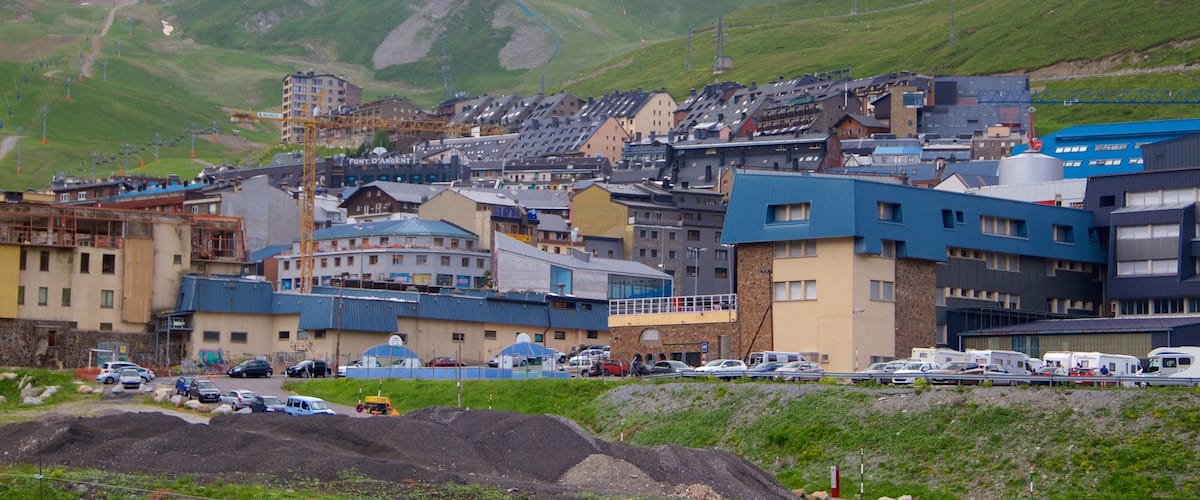 A town with buildings, a mountain, and a lighthouse.