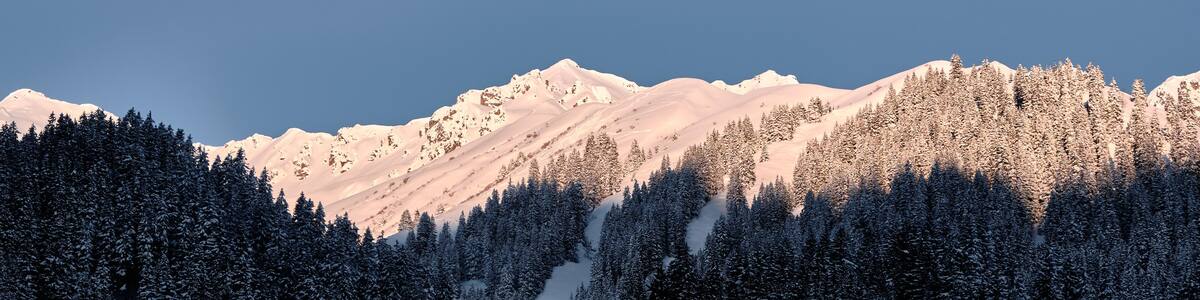 First sun in the morning at summits in montafon mountain range in Gargellen, austria