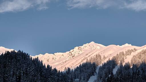 First sun in the morning at summits in montafon mountain range in Gargellen, austria