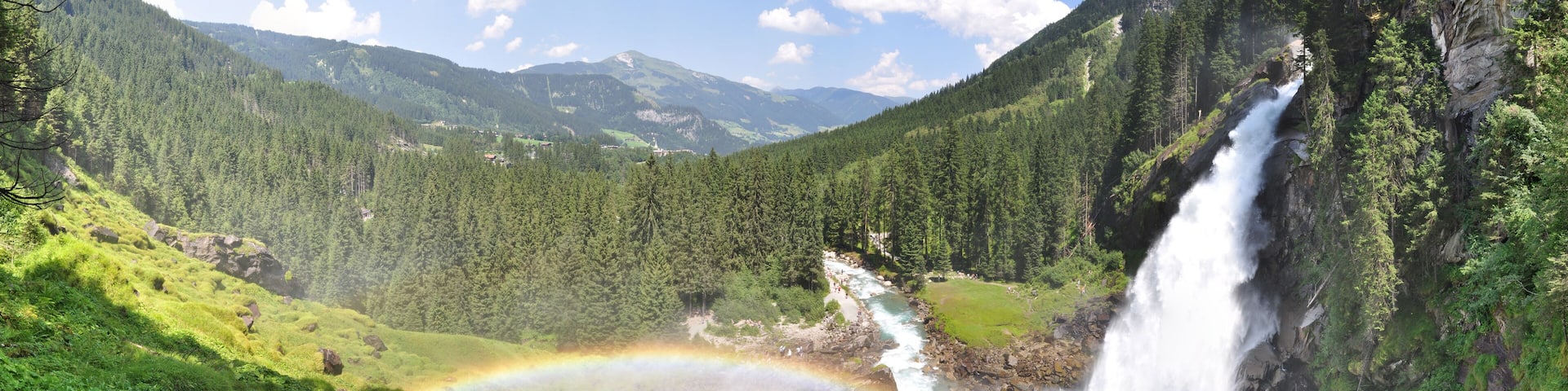 A waterfall, a river, and a mountain range.
