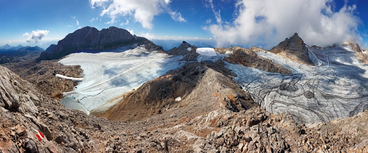 A glacier with rugged mountains in the background.