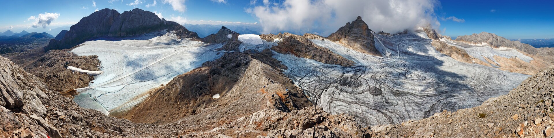 A glacier with rugged mountains in the background.