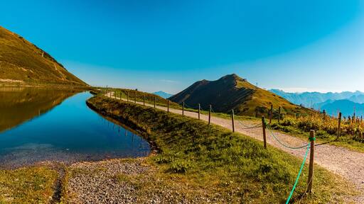 High resolution stitched panorama with reflections in a lake at the famous Kanzelwand summit, Riezlern, Vorarlberg, Austria