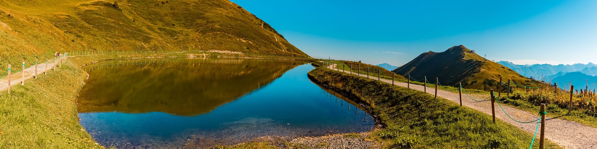 High resolution stitched panorama with reflections in a lake at the famous Kanzelwand summit, Riezlern, Vorarlberg, Austria