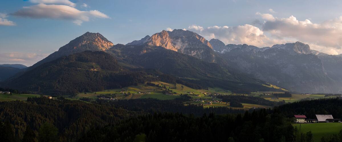 A mountain range with a village in the valley.