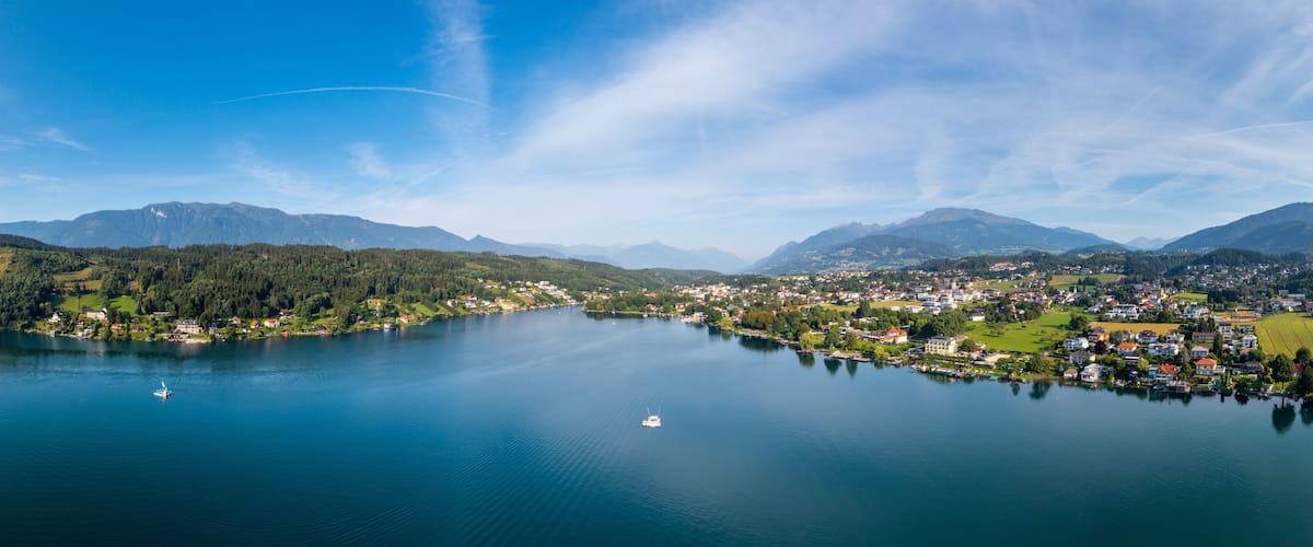 A lake surrounded by mountains and a small town.