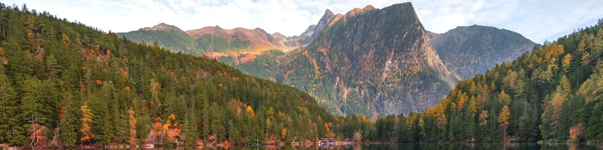 Mountain peaks of the Oetztal Alps reflected in Lake Piburger See, in autumn, near Oetz in Oetztal, Tyrol, Austria, Europe