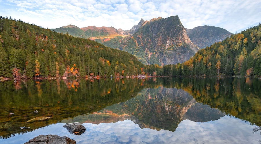 Mountain peaks of the Oetztal Alps reflected in Lake Piburger See, in autumn, near Oetz in Oetztal, Tyrol, Austria, Europe