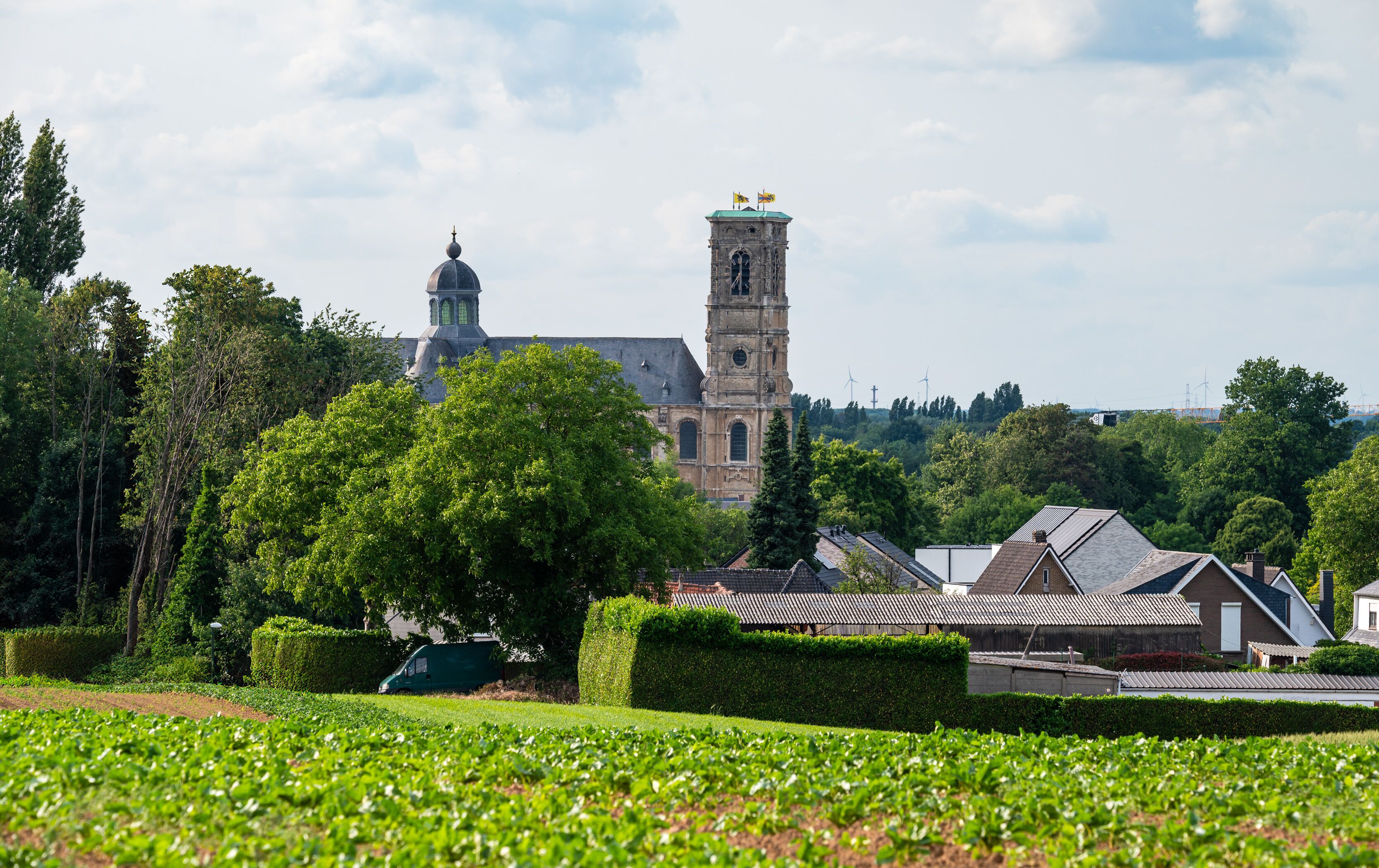 Landscape view over green fields and the Abbey tower of Grimbergen, Flemish Brabant, Belgium