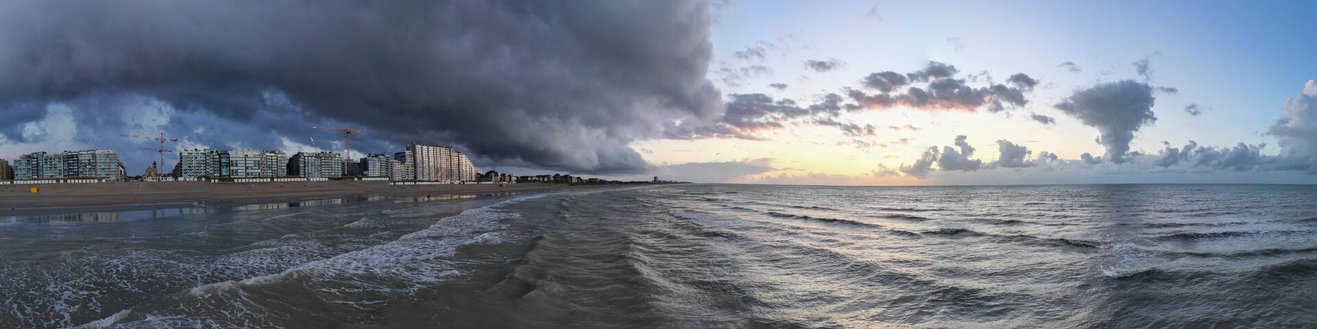 Nieuwpoort, West-Vlaanderen, Belgium, September 13th, 2025, A stunning and beautiful seascape scene showcasing dramatic storm clouds above and serene waters reflecting the sunset