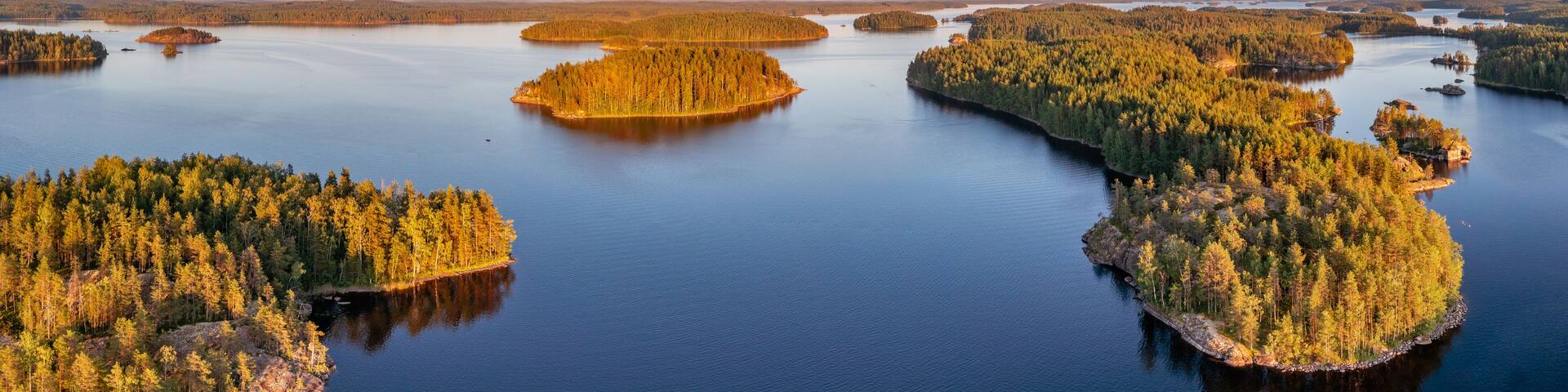 A calm lake surrounded by forested islands.