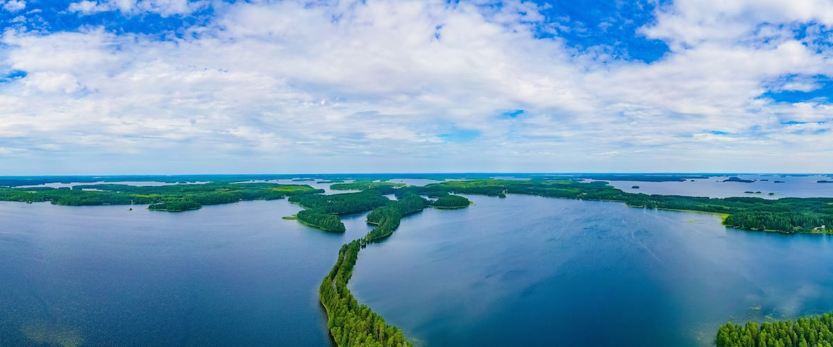 A vast lake surrounded by dense forests and small islands.