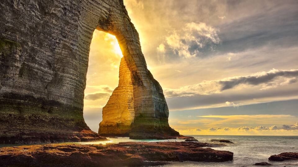 A coastal rock formation with a natural arch.