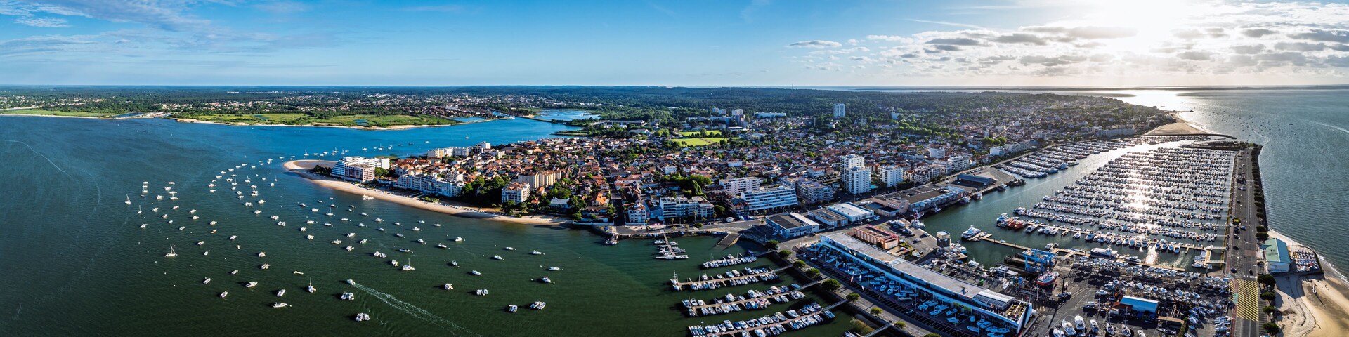 A coastal city with a marina, beach, and urban area.
