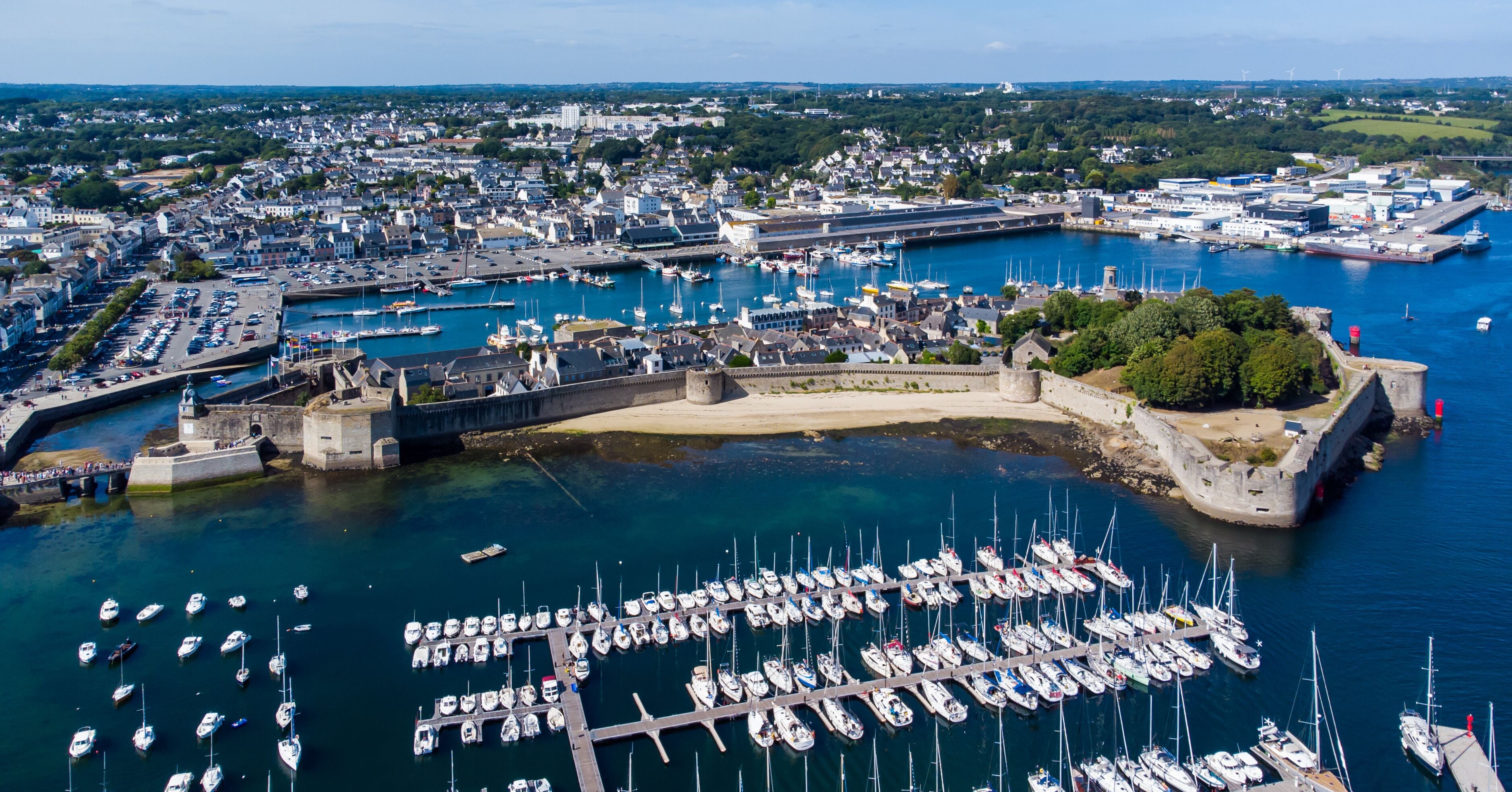 Aerial view of Concarneau, a medieval walled city in Brittany, France - Sandy beach under the fortifications of this island located in a bay along the coast of the Atlantic Ocean