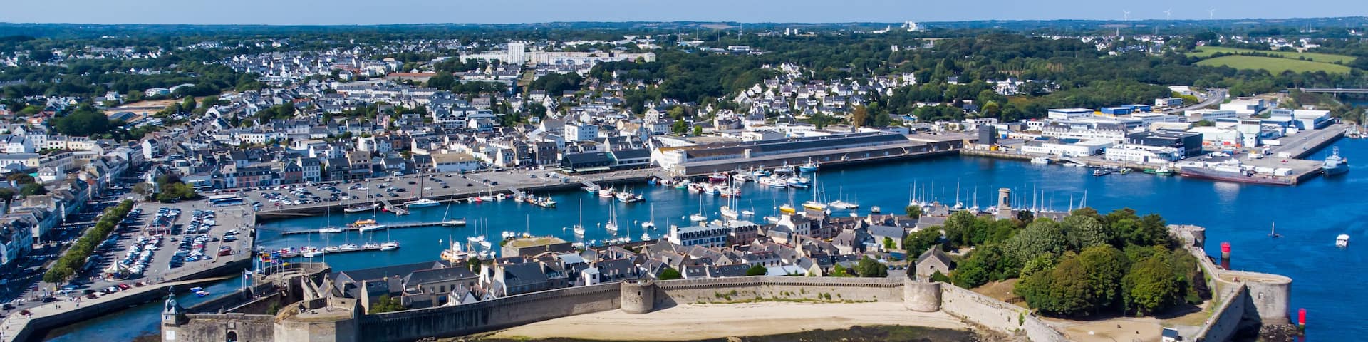 Aerial view of Concarneau, a medieval walled city in Brittany, France - Sandy beach under the fortifications of this island located in a bay along the coast of the Atlantic Ocean