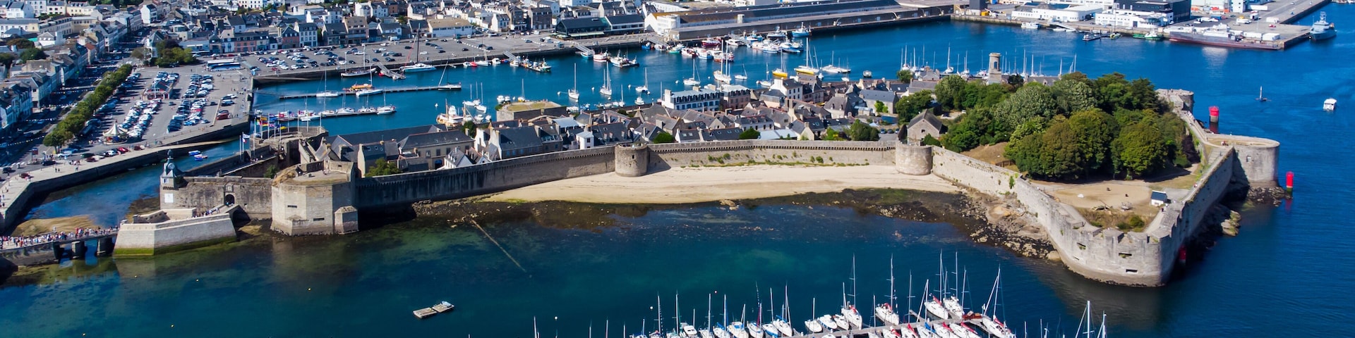 Aerial view of Concarneau, a medieval walled city in Brittany, France - Sandy beach under the fortifications of this island located in a bay along the coast of the Atlantic Ocean