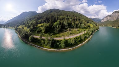360 degrees panorama of Lac Montriond seen from above. Aerial of French Alps mountain range melt water lake in summer.