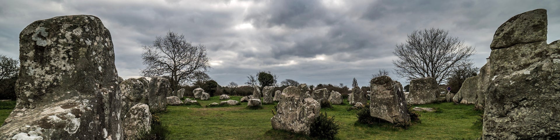 A field of large standing stones with a cloudy sky.