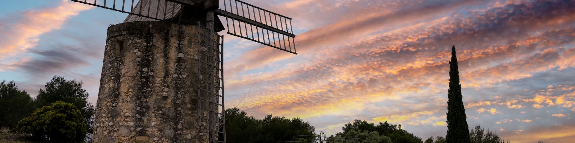 Old windmill (known as "moulin de Daudet") at sunset near Fontvieille, Provence, France