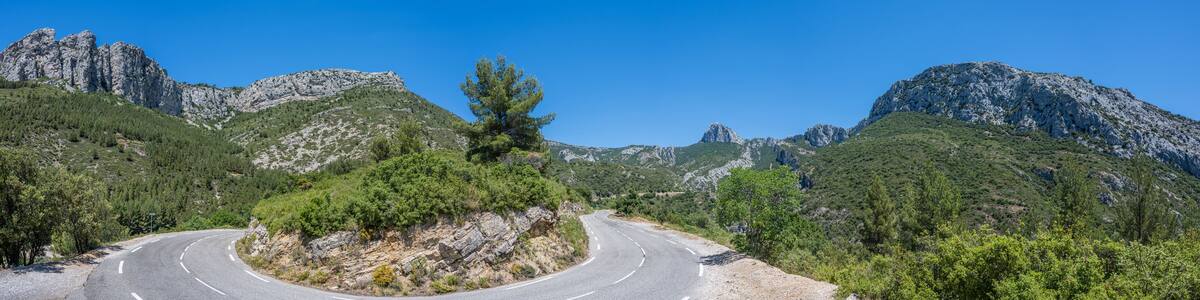 Curved mountain road and panorama view of the landscape around "vallon st pons" near Gemenos in the Bouches-du-Rhône department, Provence-Alpes-Côte d’Azur. "Pic de Bertagne" visible in background.