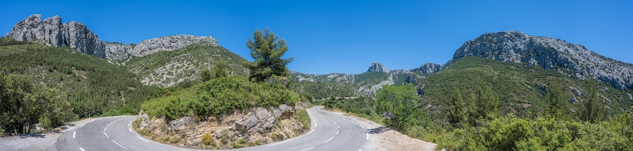 Curved mountain road and panorama view of the landscape around "vallon st pons" near Gemenos in the Bouches-du-Rhône department, Provence-Alpes-Côte d’Azur. "Pic de Bertagne" visible in background.