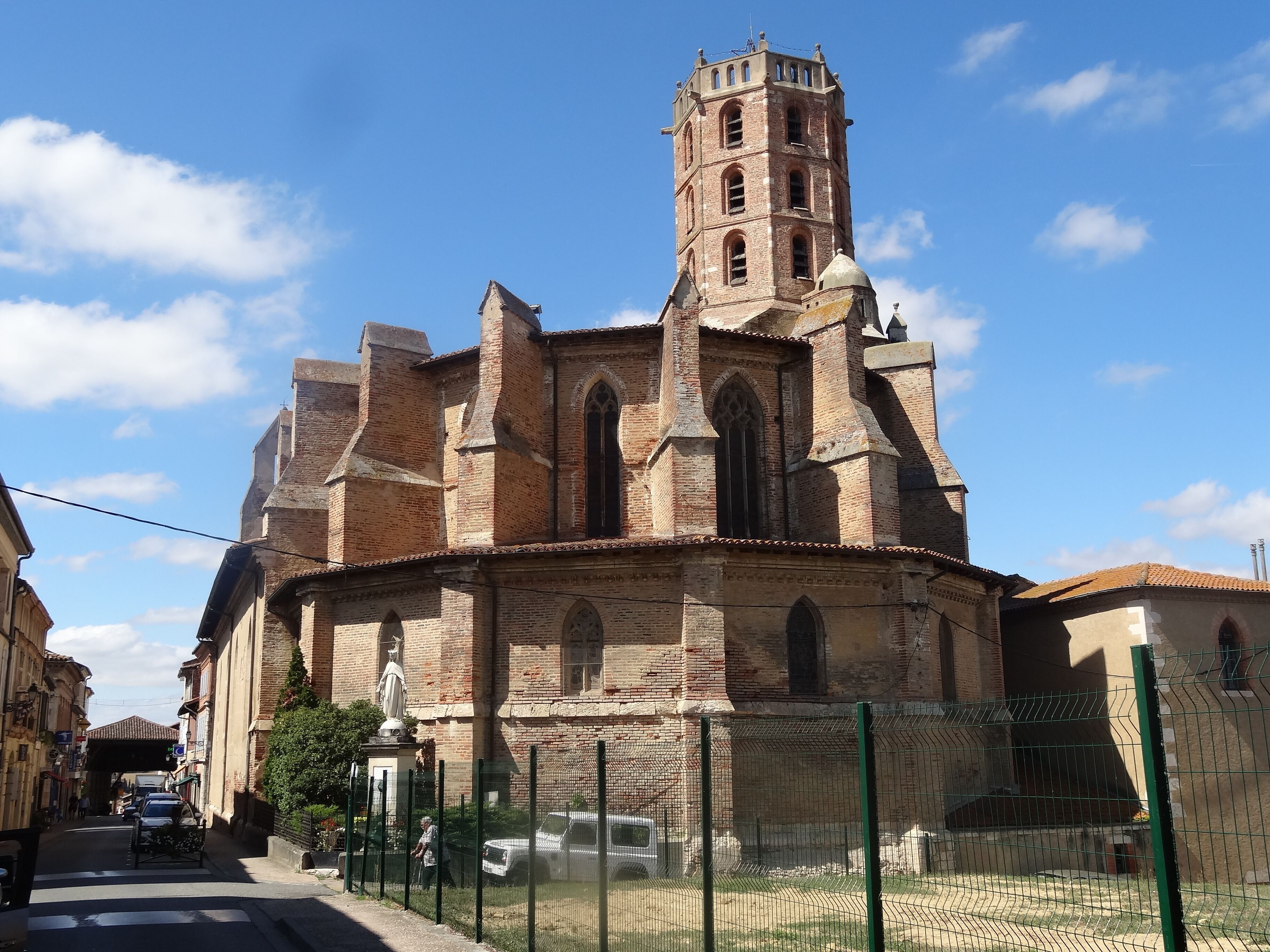 A historic church with a tall bell tower and arched windows.