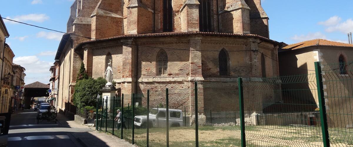 A historic church with a tall bell tower and arched windows.