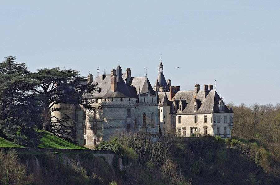 Un castillo grande e histórico con múltiples torres y un foso.