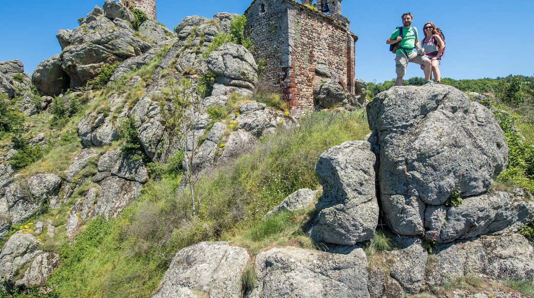 Auvergne - Haute-Loire - Saint James way - A couple of hikers at the Rochegude chapel, near Saint-Privat-d'Allier looking at the landscape.