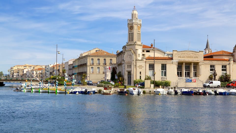 A waterfront with boats docked, a prominent clock tower, and historic buildings.