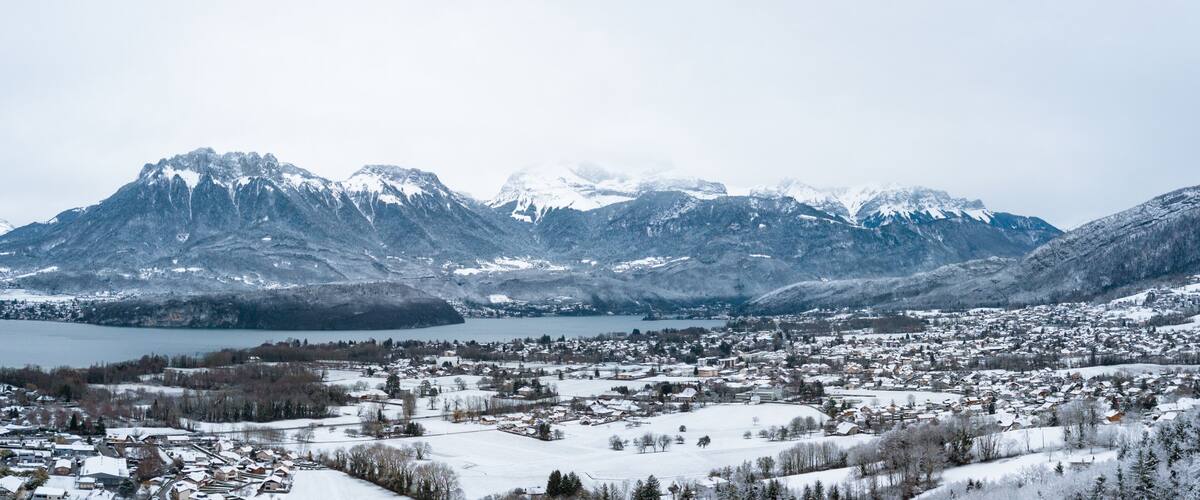 A snow-covered town with mountains in the background.