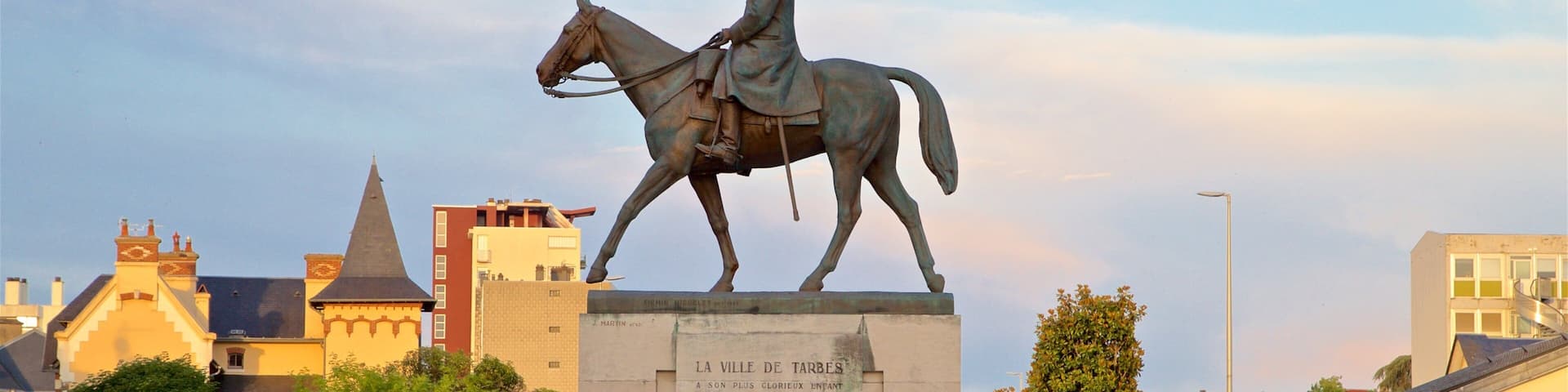 A statue of a man on horseback with a plaque in front.