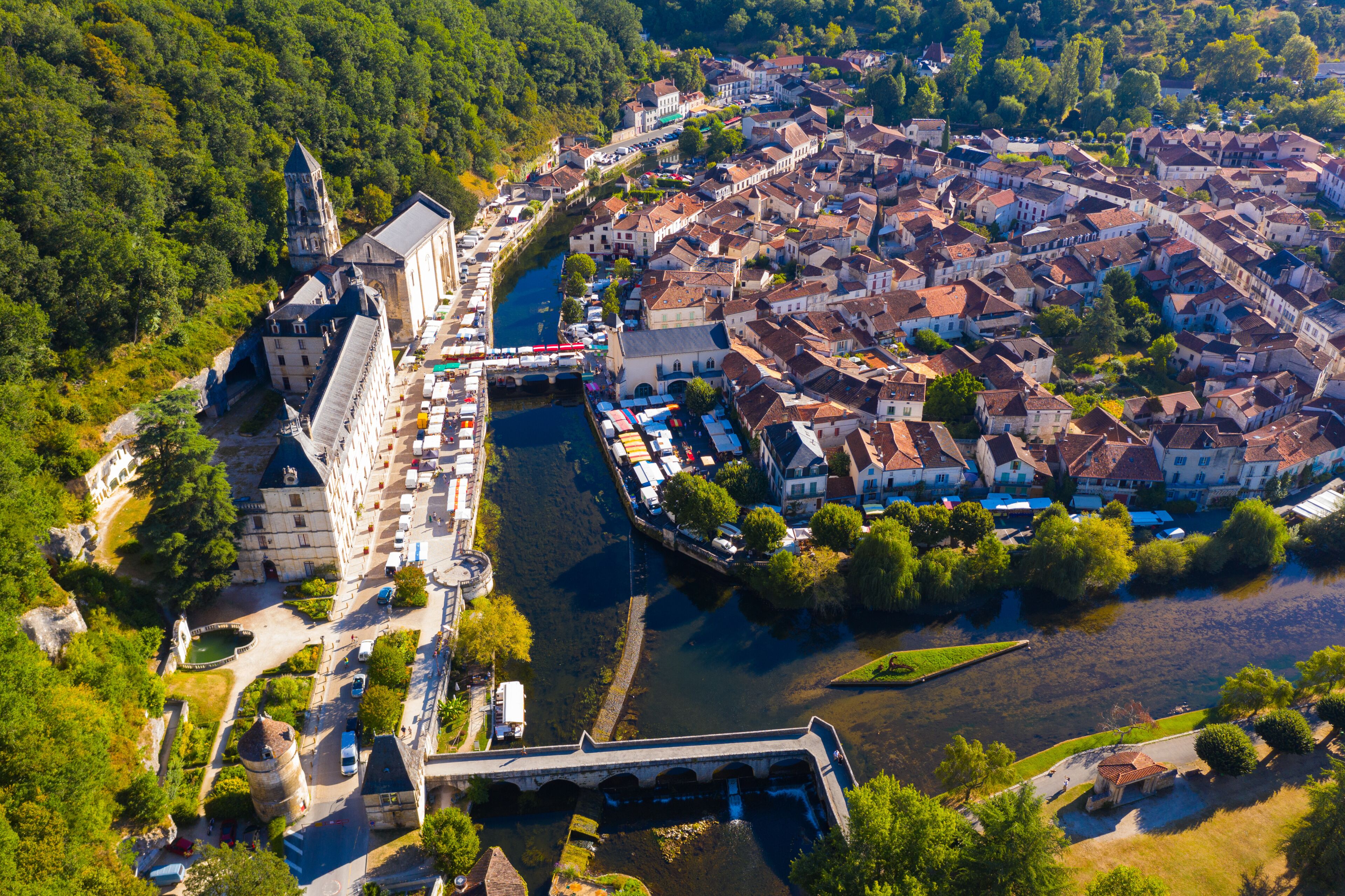 Aerial view of small French town of Brantome en Perigord on banks of bend in Dronne overlooking Town hall in summer