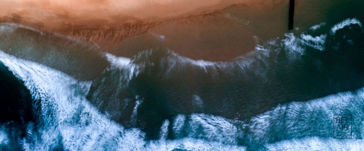 A beach with waves and a sandy shore.