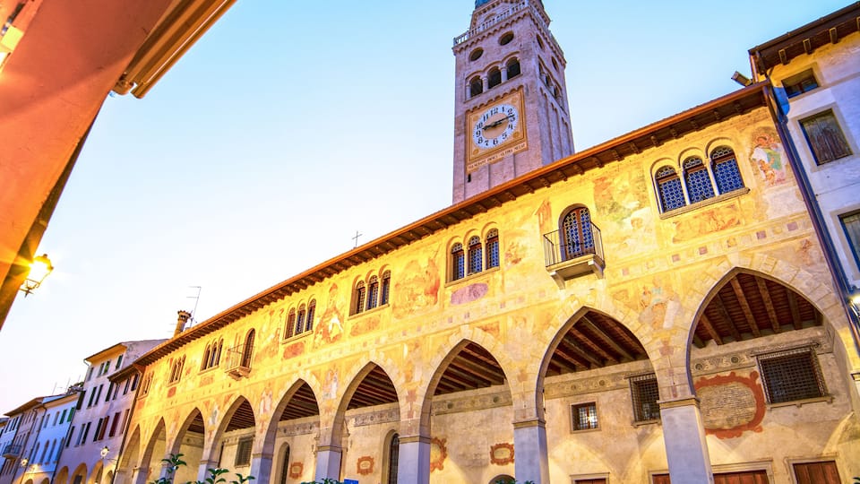 A historic building with a clock tower and arched windows.