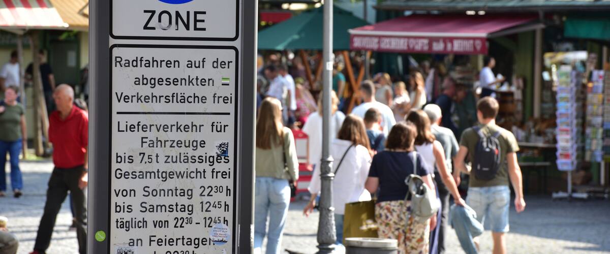 A pedestrian zone sign with a blue circle and a white background.