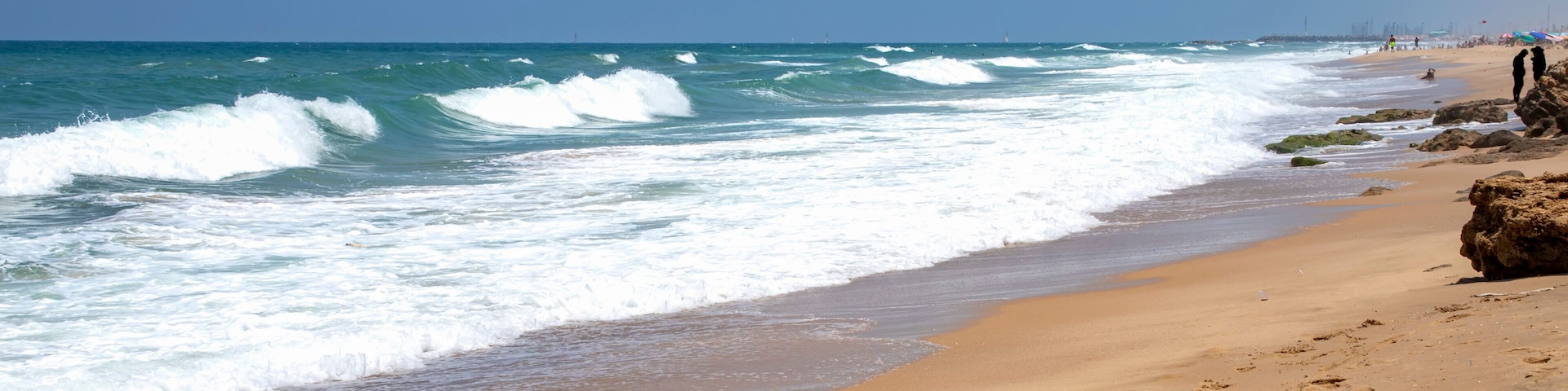Sea beach with stone formations and incident foam waves on the shore of Ashkelon National Park